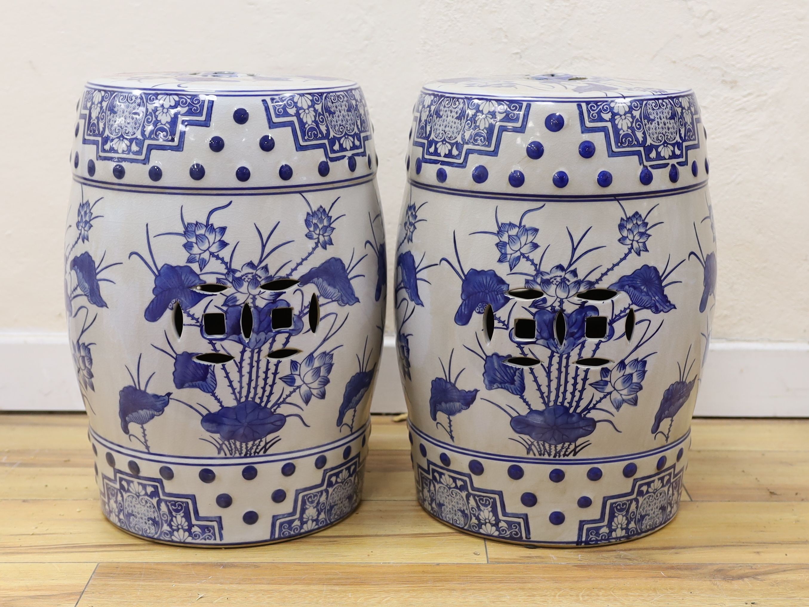 A pair of Chinese blue and white garden seats, 44 cms high.